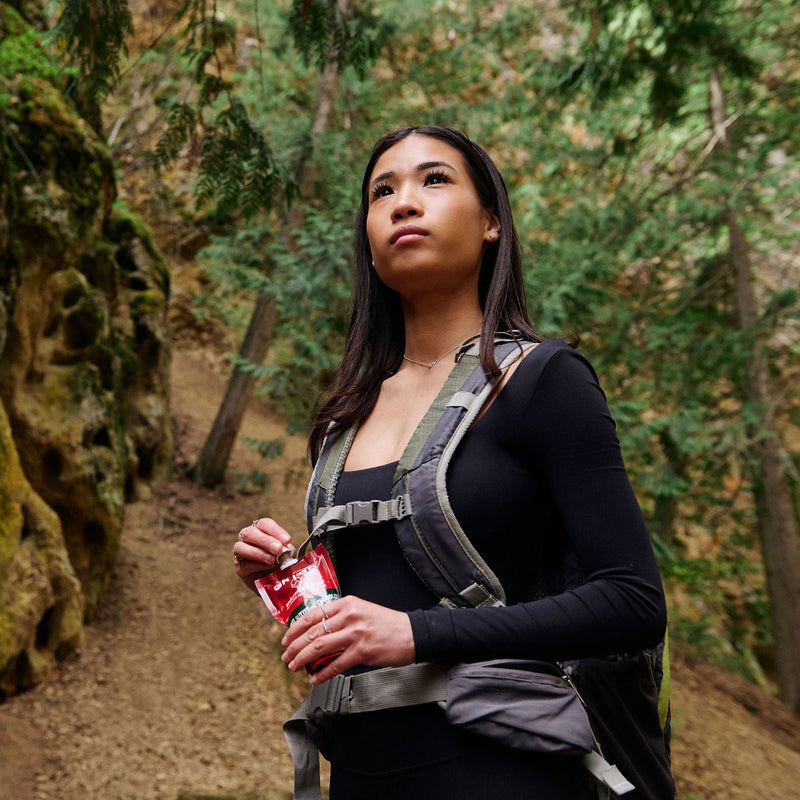 Hiker fuelling on the trail with Grynd Endurance Butter — clean real food energy for hiking and outdoor adventures in Canada
