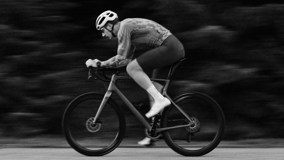Person cycling on a road with a blurred background